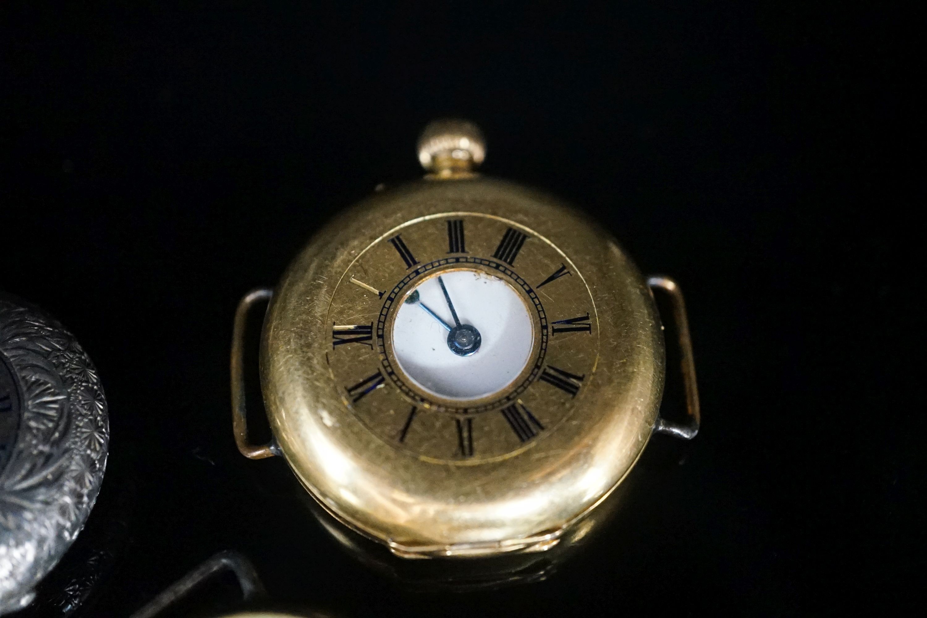 A gentleman's early 20th century continental 18k half hunter wrist watch, case diameter 33mm, gross weight 32.7 grams, together with two other silver watches.